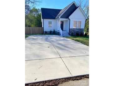 Charming home featuring a well-manicured yard and a spacious paved driveway at 126 Pleasant Hill St, Lancaster, SC 29720