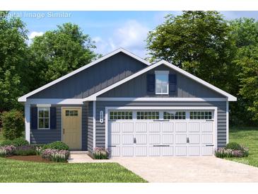Charming single-story home with a two-car garage and a well-maintained front yard at 129 Millstream Dr, China Grove, NC 28023