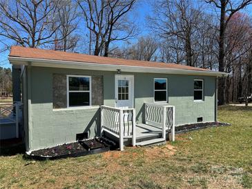 Charming one-story home featuring a cozy porch and a freshly landscaped front yard at 209 Brookview Rd, Statesville, NC 28625