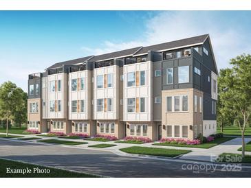Modern townhome features a roof deck, a neutral color palette, and beautiful landscaping at 233 Cherokee Rose Ln # 31, Charlotte, NC 28217