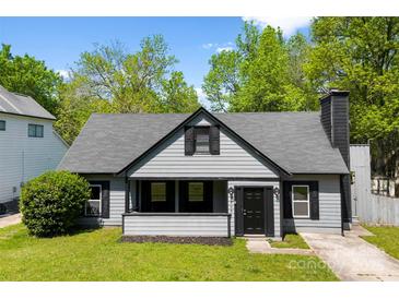 Charming one-story home featuring a cozy front porch and well-maintained landscaping at 7905 Quail Field Dr, Charlotte, NC 28227