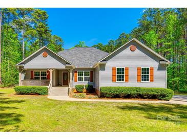 Charming single-story home with gray siding, orange shutters, covered porch, and well-manicured lawn at 1006 Chambers Rd, York, SC 29745