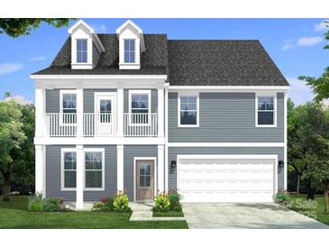 Charming two-story home featuring a covered front porch, two-car garage, and dormer windows at 115 Canary Ln # 19, Mooresville, NC 28115