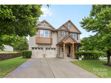 Charming two-story home featuring stone accents, well-manicured lawn, and attached two-car garage at 12604 Congregation Dr, Charlotte, NC 28278