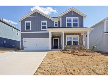 Charming two-story home with a covered porch, two-car garage, and landscaped front yard at 139 Satchel Ct, Mooresville, NC 28115
