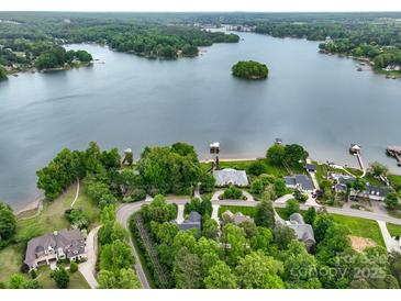 Stunning aerial view of lakefront homes surrounded by lush trees and calm water at 166 Wilson Lake Rd, Mooresville, NC 28117