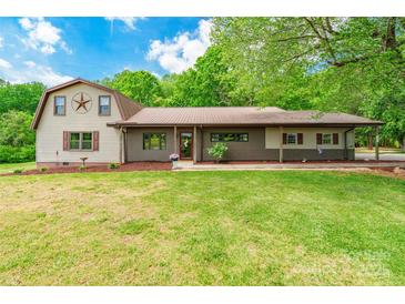 Charming two-story home with a spacious front lawn and metal roof at 286 Bell Farm Rd, Statesville, NC 28625