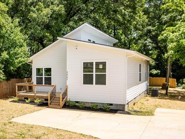 Charming home boasts a modern design, natural light, and a lovely wooden deck at 3007 West Blvd, Charlotte, NC 28208