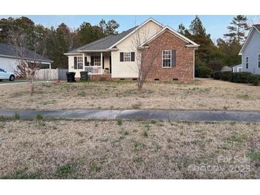 Charming single-Gathering home featuring a brick facade and inviting front porch at 333 E Village E Dr, Monroe, NC 28112