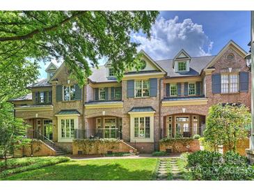 Charming brick townhomes with manicured lawns and beautiful landscaping, creating inviting curb appeal at 4020 Barclay Downs Dr, Charlotte, NC 28209