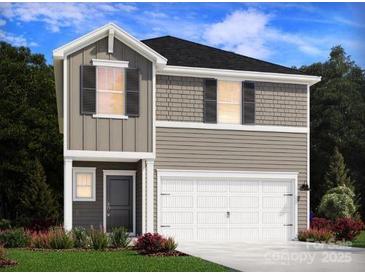 Charming two-story home featuring a two-car garage and a combination of siding and brick accents at 5018 Poplin Vly, Cherryville, NC 28021