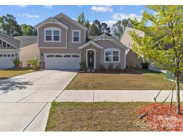 Charming two-story home with a well-manicured lawn and inviting curb appeal on a sunny day at 5024 Colline Ct, Charlotte, NC 28216