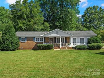 Charming single story home featuring a well-manicured lawn and inviting front porch at 5159 Taxahaw Rd, Lancaster, SC 29720