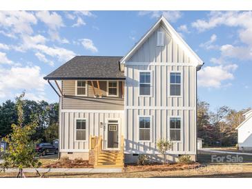 Charming two-story home featuring a modern exterior, inviting entrance, and well-manicured front lawn at 106 Walters St, Huntersville, NC 28078