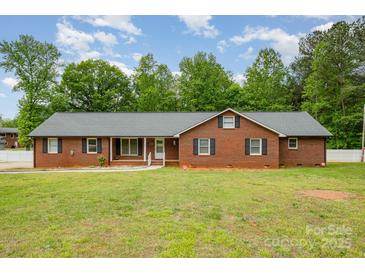 Charming single-story brick home featuring a well-manicured lawn and classic black shutters at 1376 Garland Ln, Lincolnton, NC 28092