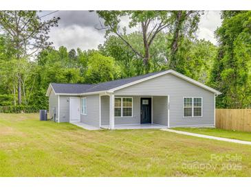 Charming single-story home featuring a well-maintained lawn, covered porch, and light gray siding at 1495 Memorial Park Rd # 10, Lancaster, SC 29720