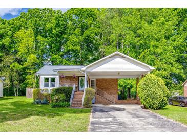 Charming one-story home featuring a covered carport, brick accents, and a lush green lawn at 1623 Mulberry Cir, Rock Hill, SC 29730