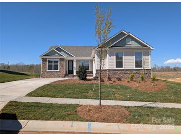 Charming single-story home with stone accents, well-manicured lawn, and inviting curb appeal at 2081 Fordhill St, Rock Hill, SC 29732