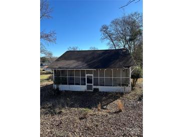 Vintage one-story home featuring a screened-in porch and classic architectural design at 29 Pinecrest Ave, Great Falls, SC 29055