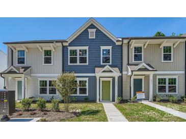 Charming townhome with blue siding, white trim, and a vibrant green front door at 3015 Howell Mill Rd, Charlotte, NC 28208