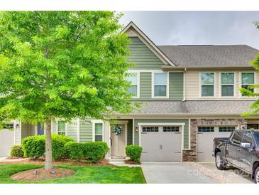 Inviting townhome with a well-manicured lawn, lush green tree, and charming curb appeal at 306 Willow Wood Ct, Matthews, NC 28104