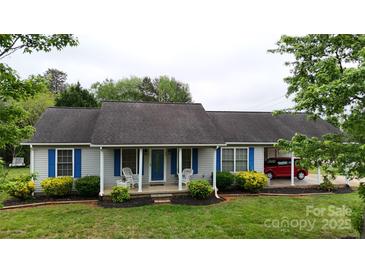 Charming single-story home with blue shutters, covered porch, and well-maintained landscaping at 3124 Banks St, Lincolnton, NC 28092