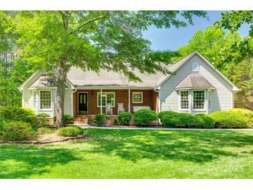 Charming single-story home with lush lawn, mature trees and a covered brick porch at 4307 Edgeland Rd, Edgemoor, SC 29712