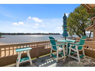 Balcony featuring a table, chairs, and stunning lake view perfect for relaxing and entertaining at 657 Portside Dr, Davidson, NC 28036