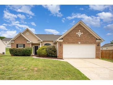 Charming brick and siding home with a well-manicured lawn and attached two-car garage at 6849 Blake Brook Dr, Concord, NC 28025