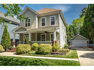 Charming two-story home with a well-manicured lawn and inviting front porch. Detached garage in the back at 7409 Gilderstern Glen Ct, Huntersville, NC 28078