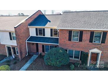 Brick townhome featuring black shutters, gray roof and small front yard at 825 21St Ne Ave, Hickory, NC 28601