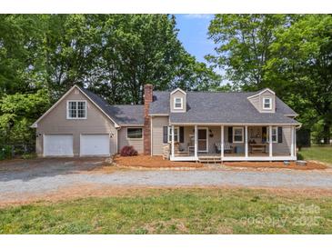 Charming traditional home with a welcoming front porch and a two-car attached garage at 10139 Arlington Church Rd, Mint Hill, NC 28227