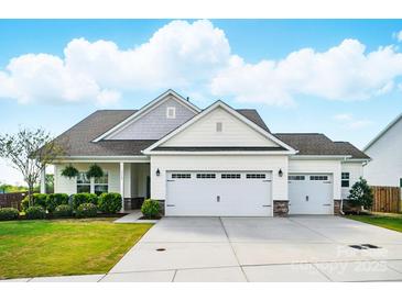 Charming one story home featuring manicured landscaping and a three car garage at 1116 Brooksland Pl, Waxhaw, NC 28173