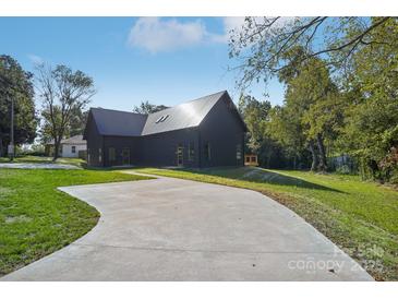 Stunning modern home with metal roof, expansive driveway, and lush green lawn at 122 Laura Rd # A, Mooresville, NC 28117