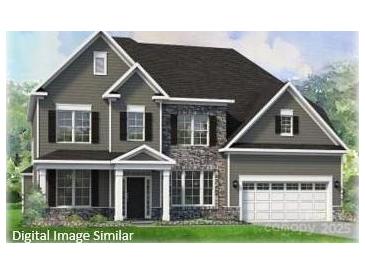 Charming two-story home featuring stone accents, a welcoming front porch, and an attached two-car garage at 124 Adalyn Ivy Ln # 3, Mooresville, NC 28115