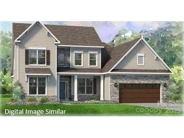 Charming two-story home featuring stone accents, attached garage, and manicured lawn at 128 Adalyn Ivy Ln # 5, Mooresville, NC 28115