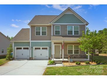 Charming two-story home with a two car garage, beautiful landscaping, and welcoming front porch at 13408 Portside Ln, Lancaster, SC 29720