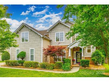 Inviting two-story home featuring stone accents, manicured lawn, and mature landscaping at 1418 Lonan Dr, Waxhaw, NC 28173