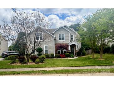 Charming two-story home with beautiful landscaping and a well-manicured lawn, enhancing curb appeal at 1418 Lonan Dr, Waxhaw, NC 28173