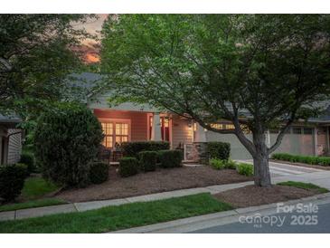 Charming exterior with well-manicured landscaping, inviting porch, and attached two-car garage at 142 Aztec Cir, Mooresville, NC 28117