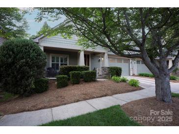 Charming home featuring a beautifully landscaped front yard with mature trees and inviting curb appeal at 142 Aztec Cir, Mooresville, NC 28117