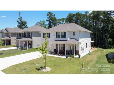 Beautiful two-story home with white siding, a landscaped lawn and a welcoming front porch at 2220 Sussex Rd, York, SC 29745