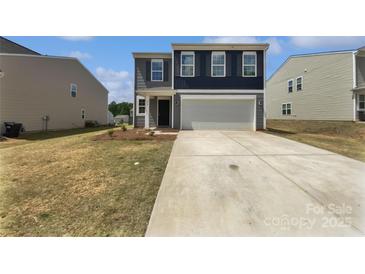 Two-story home with a two-car garage, concrete driveway, and a well-manicured lawn at 250 Marinna Joy Cir, Rockwell, NC 28138