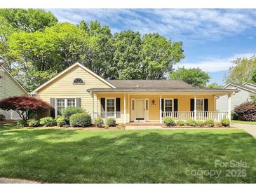 Charming one-story home featuring a well-manicured lawn, covered porch, and inviting curb appeal at 2506 Breuster Dr, Charlotte, NC 28210