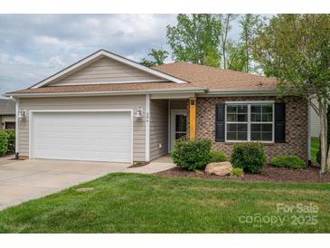 Charming single-story home featuring brick and vinyl siding, an attached garage and manicured front yard at 286 Hemlock Bluff Ct, Denver, NC 28037