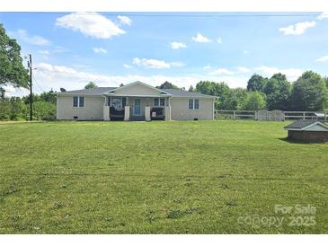 Charming ranch style home with a well manicured lawn and covered front porch at 3100 Wallace Rd, Midland, NC 28107