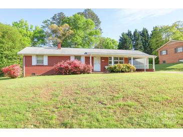 Charming brick home featuring a well-maintained lawn and colorful landscaping at 3119 6Th Sw Ave, Hickory, NC 28602