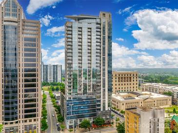 Modern high rise building with glass windows, balconies, and surrounding city views on a sunny day at 333 W Trade St # 800, Charlotte, NC 28202