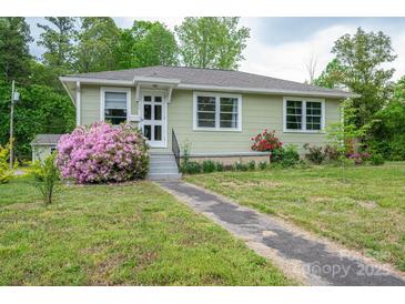 Charming single-story home with lovely landscaping, flowering bushes and a concrete walkway at 400 Houser St, Cherryville, NC 28021