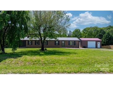 Charming brick ranch home with metal roof, mature tree, and a detached garage at 4815 Rifle Range Rd, Conover, NC 28613